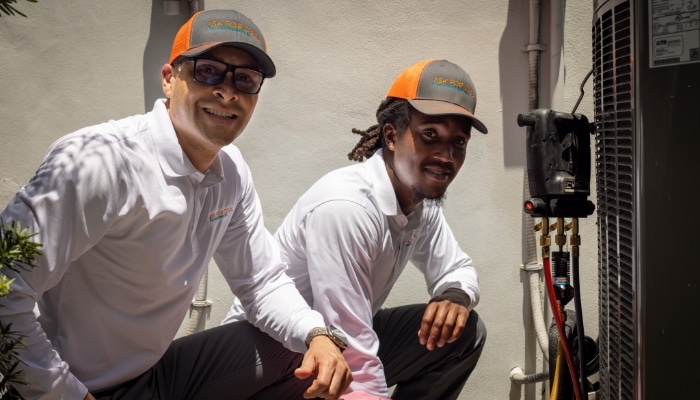Kneeling Technicians With Ac Unit Kneeling Technicians With Ac Unit